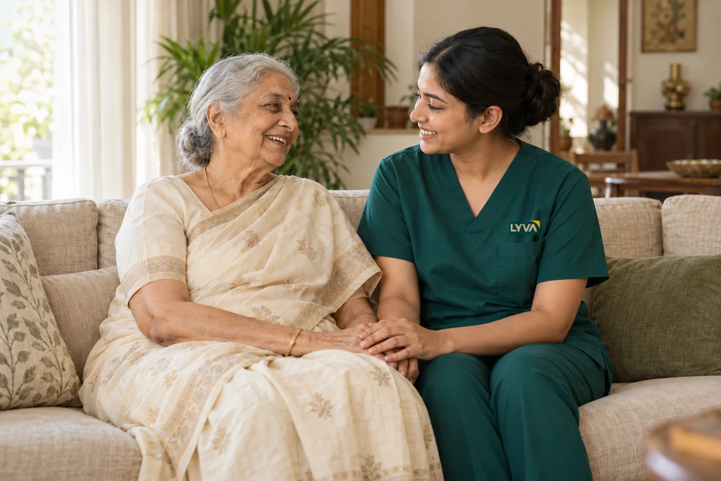 A care professional sharing a warm moment with an older woman at home